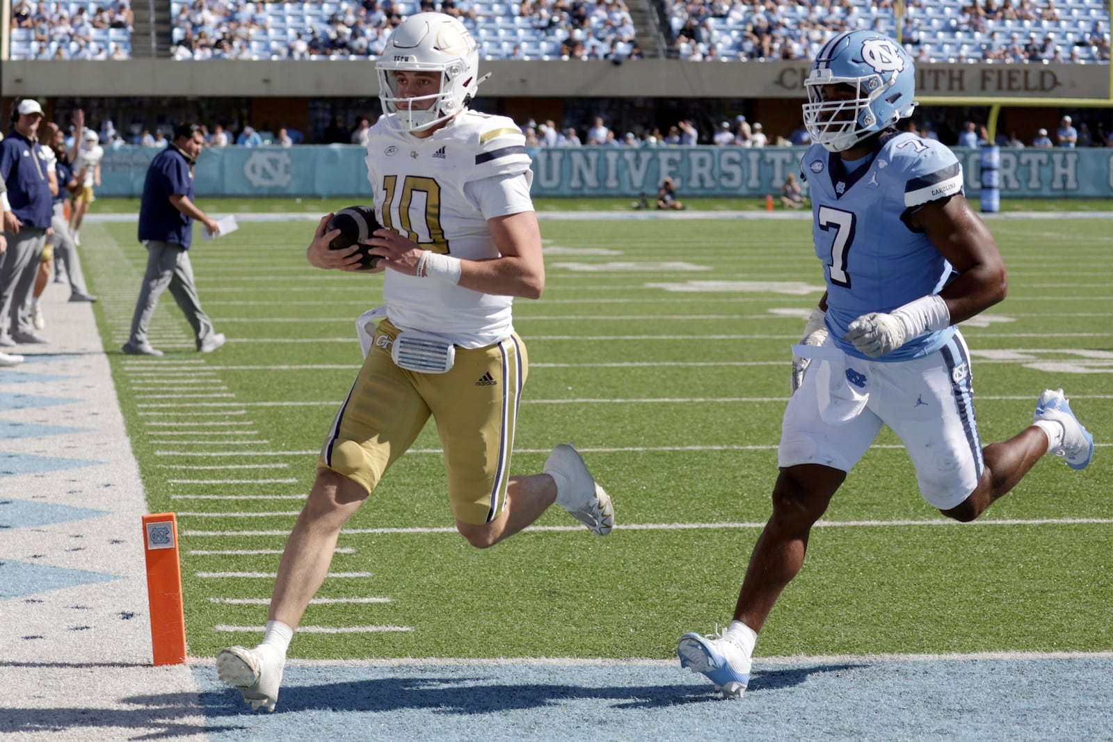 Georgia Tech quarterback Haynes King (10) gets past North Carolina defensive end Kaimon Rucker (7) for a touchdown during the second half of an NCAA college football game, Saturday, Oct. 12, 2024, in Chapel Hill, N.C. (AP Photo/Chris Seward)