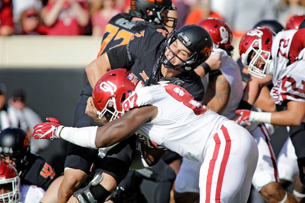 STILLWATER, OK - NOVEMBER 04: Quarterback Mason Rudolph #2 of the Oklahoma State Cowboys is hit by defensive end D.J. Ward #87 of the Oklahoma Sooners at Boone Pickens Stadium on November 4, 2017 in Stillwater, Oklahoma. Oklahoma defeated Oklahoma State 62-52.  (Photo by Brett Deering/Getty Images)