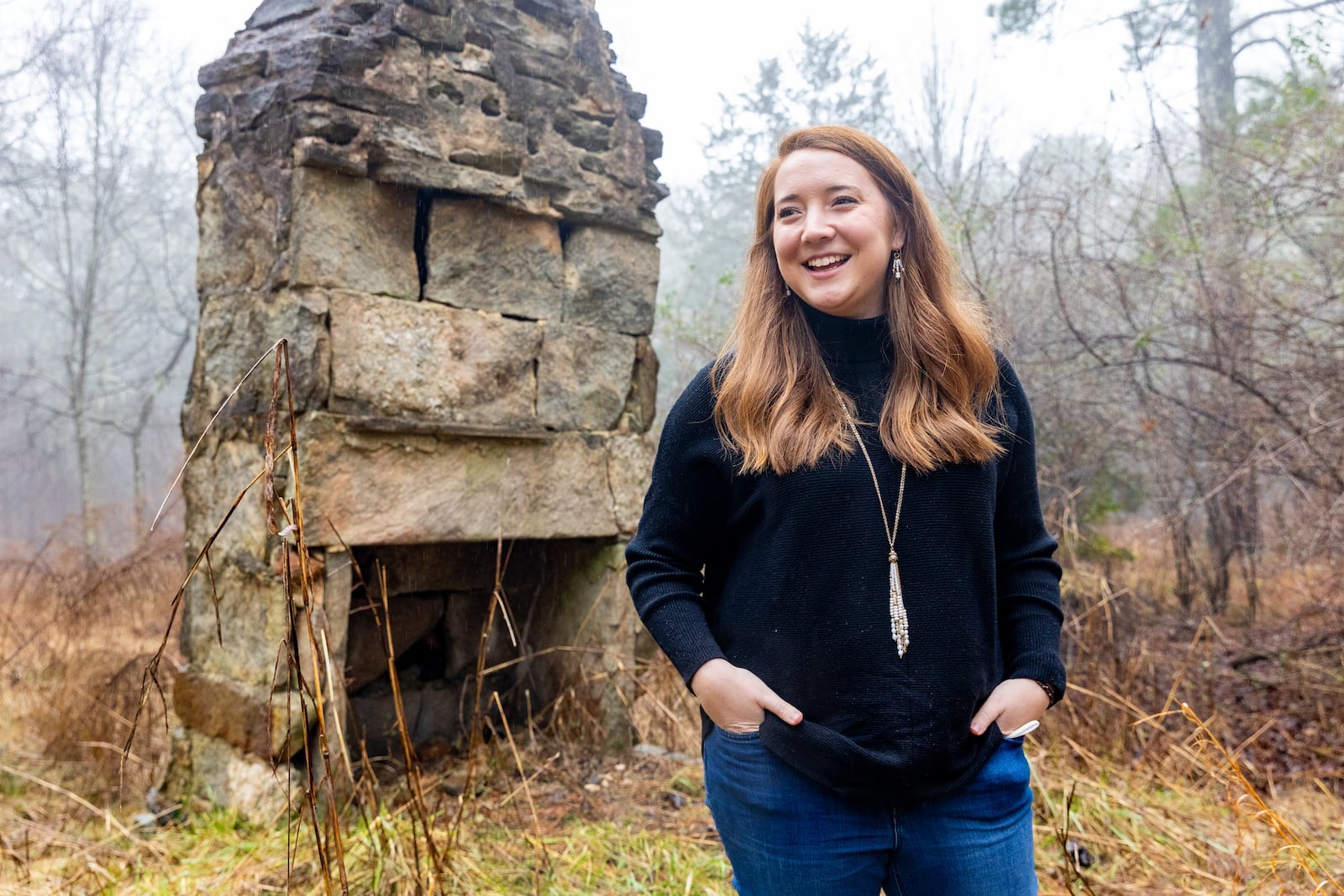 A University of Georgia study recently outlined the history and need for preservation of a tract of land in eastern Gwinnett that runs near GA 316.  The area includes about 2,000 acres and includes a farmhouse from 1894, a water well, one of the oldest dirt road in the state and several homesteads where only a chimney or dandelions remain as a marker on Thursday, Feb 3, 2022.  Caroline Hinton is in front of what was her family’s original homestead in the late 1800s; she and her family are still active farmers and stewards of the property.  Hinton works with UGA and her family will maintain a portion of their family farm while developments occurs.  The Rowen Study suggests environmentally conscious development with trails and historical highlights.  (Jenni Girtman for The Atlanta Journal Constitution)