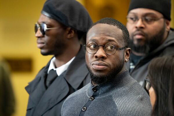 In this Monday, Feb. 24, 2020 photo, brothers Abimbola Osundairo, left and Olabinjo Osundairo, center, depart after attending a court appearance for actor Jussie Smollett at the Leighton Criminal Courts Building in Chicago. The brothers, who have said they helped Smollett stage a racist and homophobic attack in Chicago last year, no longer intend to cooperate with authorities, according to their attorney. But one legal expert said even if they stop cooperating it wonât hurt the case because prosecutors can present at trial the brothersâ previous testimony before a grand jury. (Brian Cassella/Chicago Tribune via AP)