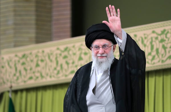 In this photo released by an official website of the office of the Iranian supreme leader, Supreme Leader Ayatollah Ali Khamenei waves to the crowd during a meeting with school and university students, in Tehran, Iran, Saturday, Nov. 2, 2024. (Office of the Iranian Supreme Leader via AP)