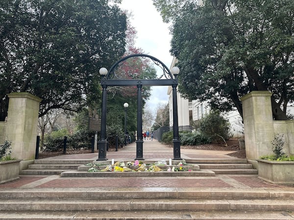 Flowers were left at the Arch at the University of Georgia after Laken Riley, a 22-year-old nursing student, was found dead on the campus last month. A man authorities say entered the country illegally in 2022 has been charged with murder in her death. (Fletcher Page/The Atlanta Journal-Constitution/TNS)