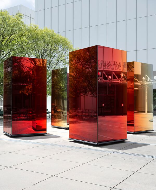 Striking contrast: Sabine Marcelis’ columns of red and orange mirrored glass are set against the white concrete of the piazza floor and surrounded by the white metal flashing on the facade of the High Museum.