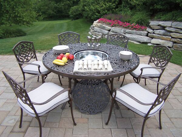 An ice bucket sits in the middle of the Oakland Living cast aluminum dining set. Contributed by Wayfair