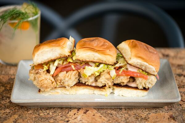 Virginia Oyster Sliders with lettuce, tomato, pickle, Datil pepper aioli, and soft roll. Photo credit- Mia Yakel.