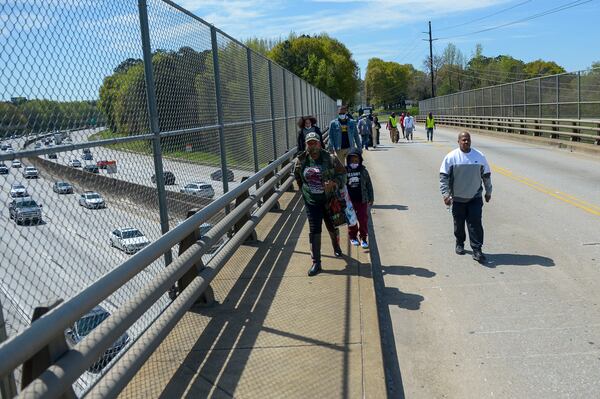 Participants walk along Bolton Road to the site of the former Chattahoochee Brick Company during a sacred event to commemorate the lives lost during the period the company used the convict lease system. The event included a procession, prayers, libations, community testimonials, and site consecration Saturday, April 3, 2021, in Atlanta. (Photo: Daniel Varnado for The Atlanta Journal-Constitution)