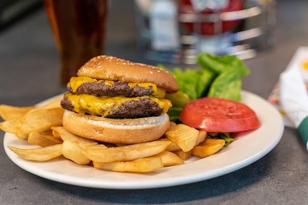 Three Dollar Cafe offers a burger with American cheese on a brioche bun. Courtesy of Three Dollar Cafe