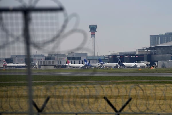 Planes are parked at the Terminal as Britain's Heathrow Airport has closed for the full day Friday after an electrical substation fire knocked out its power, disrupting flights for hundreds of thousands of passengers at one of Europe's biggest travel hubs in London, Friday, March 21, 2025.(AP Photo/Kin Cheung)