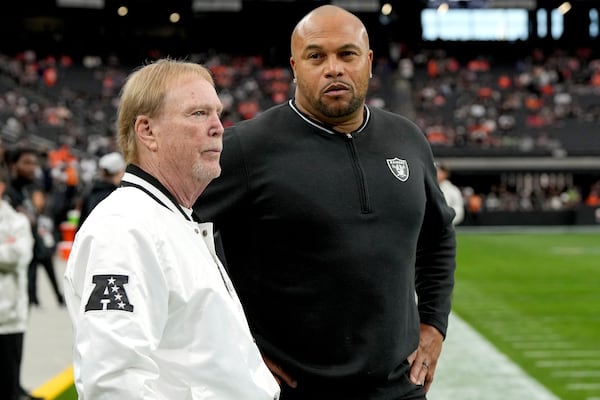 Las Vegas Raiders Head Coach Antonio Pierce, right, and owner Mark Davis talk prior to an NFL football game against the Denver Broncos, Sunday, Nov. 24, 2024, in Las Vegas. (AP Photo/Rick Scuteri)