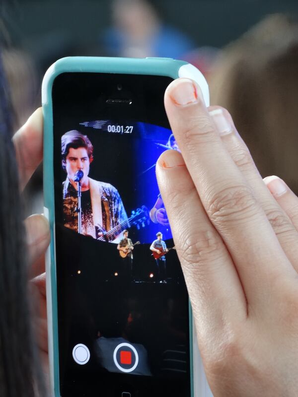 A teen in front of me videotaped Sam's cover of Ed Sheeran's "Lego House" performance, arguably his strongest one that goes back to his original audition. Likable kid but he certainly does not fill up an amphitheatre with his presence. CREDIT: Rodney Ho/rho@ajc.com