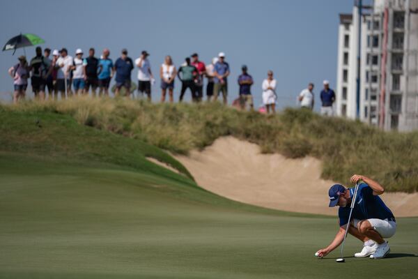 Paul Waring of England lines up a putt on the 1st green in the final round of Abu Dhabi Golf Championship in Abu Dhabi, United Arab Emirates, Sunday, Nov. 10, 2024. (AP Photo/Altaf Qadri)