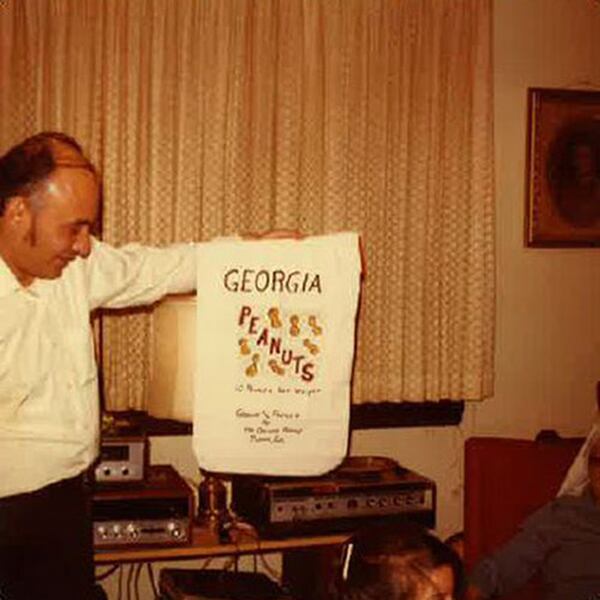 Richard Figueras, father of Atlanta Journal-Constitution Dining Editor Ligaya Figueras, holds the packaging from a gift of Georgia peanuts, one of his favorite snack foods, in this Christmas photo taken in the late 1970s.  LIGAYA FIGUERAS / LIGAYA.FIGUERAS@AJC.COM