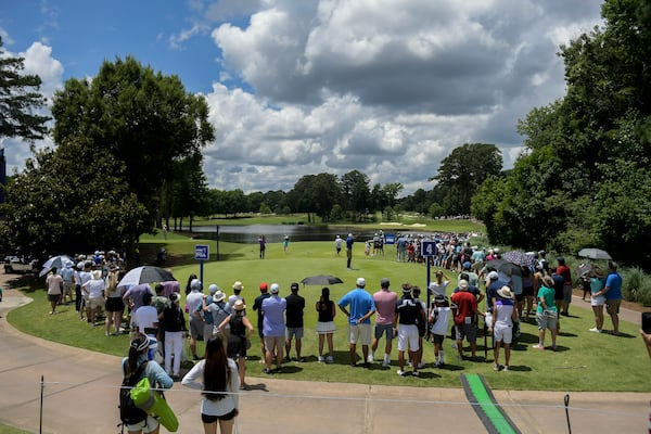 Spectators watch as players tee off from the fourth hole during the final round of the KPMG Women’s PGA Championship Sunday, June 27, 2021, at the Atlanta Athletic Club in Johns Creek. (Daniel Varnado/For the AJC)