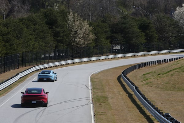 Welch drives the red car at the Porsche Experience Center Atlanta. Tyson Horne / tyson.horne@ajc.com