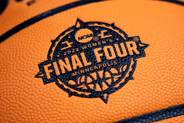 FILE - A logo is seen on a basketball during a practice session for a college basketball game in the final round of the Women's Final Four NCAA tournament Saturday, April 2, 2022, in Minneapolis. (AP Photo/Charlie Neibergall, File)