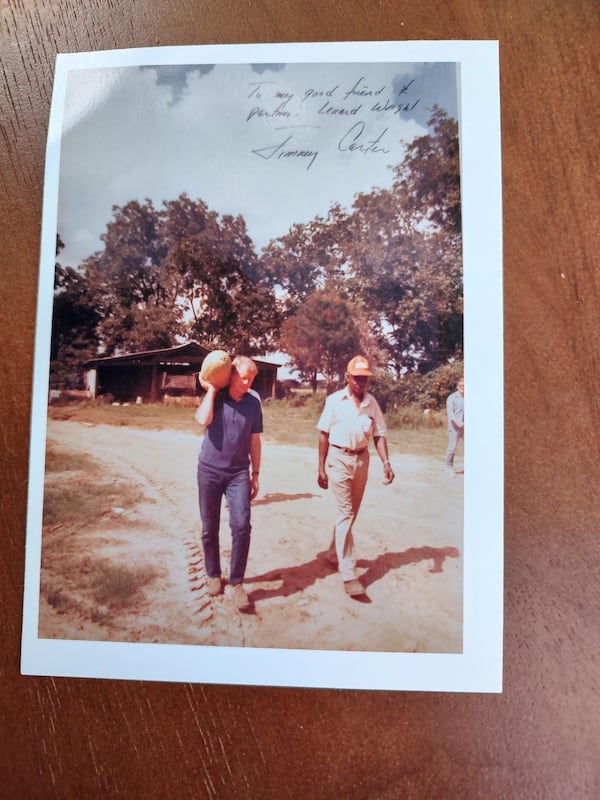 Autographed photo of President Carter carrying a watermelon and Leonard Wright, Bernstine Hollis' father, walking alongside him.  Autographed photo reads "to my good friend and partner."  