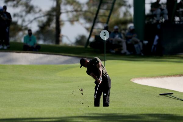 Tiger Woods hits his tee shot on the 3rd hole with no patrons during the first round of the Masters Thursday, Nov. 12, 2020, at Augusta National. (Curtis Compton / Curtis.Compton@ajc.com)