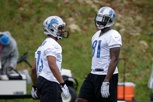 Detroit Lions wide receiver Calvin Johnson, right, who is recovering from an injury, and wide receiver Golden Tate take part in a training session at Pennyhill Park Hotel in Bagshot, England, Thursday, Oct. 23, 2014. The Atlanta Falcons will play the Detroit Lions in an NFL football game at London's Wembley Stadium on Sunday. (AP Photo/Matt Dunham) Calvin Johnson (right) goes incognito at the Lions' practice Thursday. (Matt Dunham/AP photo)