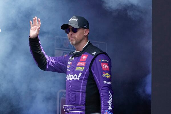 FILE - Denny Hamlin is introduced before a NASCAR Cup Series auto race at Michigan International Speedway, Aug. 18, 2024, in Brooklyn, Mich. (AP Photo/Carlos Osorio, File)