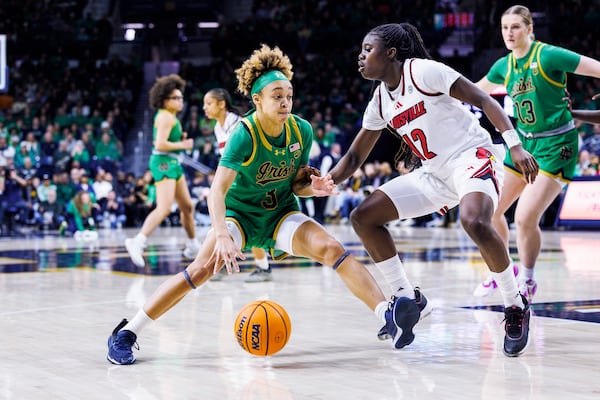 Notre Dame guard Hannah Hidalgo (3) drives as Louisville guard Ja'Leah Williams (12) defends during the first half of an NCAA college basketball game Sunday, March 2, 2025, in South Bend, Ind. (AP Photo/John Mersits)