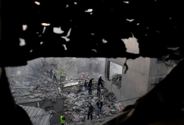 Rescue workers and people search for victims at the site of an Israeli airstrike that hit central Beirut, Lebanon, Saturday, Nov. 23, 2024. (AP Photo/Hassan Ammar)