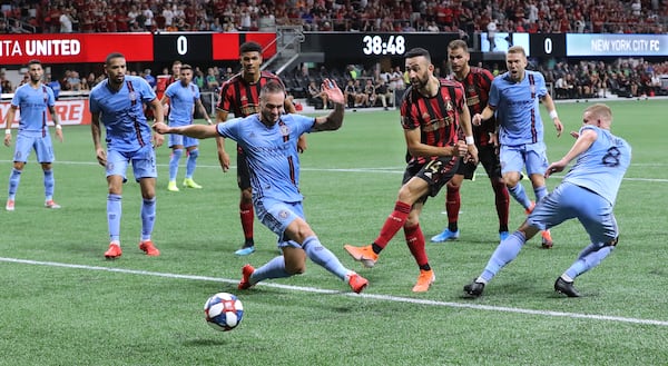 August 11, 2019 Atlanta: Atlanta United midfielder Justin Meram gets off a shot between New York City FC defenders in front of their goal in their soccer match on Sunday, August 11, 2019, in Atlanta.   Curtis Compton/ccompton@ajc.com