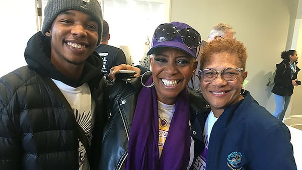 Cleophus Johnson, Jr., his mother Joya Poole, and Rozell Green lit up after Cleophus took a photograph of Gov. Brian Kemp standing with his mom, Poole. Kemp took a minute to greet them. The three were at the Georgia Freight Depot Tuesday, Jan. 28, 2020 for Addiction Recovery Awareness Day across from the state Capitol. Kemp spoke to the crowd along with other state officials. PHOTO by Ariel Hart / ahart@ajc.com