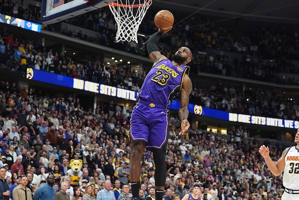 Los Angeles Lakers forward LeBron James dunks the ball for a basket in the first half of an NBA basketball game against the Denver Nuggets Saturday, Feb. 22, 2025, in Denver. (AP Photo/David Zalubowski)