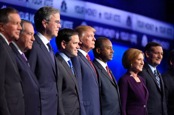 Republican presidential candidates, from left, John Kasich, Mike Huckabee, Jeb Bush, Marco Rubio, Donald Trump, Ben Carson, Carly Fiorina, and Ted Cruz take the stage during the CNBC Republican presidential debate at the University of Colorado, Wednesday, Oct. 28, 2015, in Boulder, Colo. (AP Photo/Mark J. Terrill)