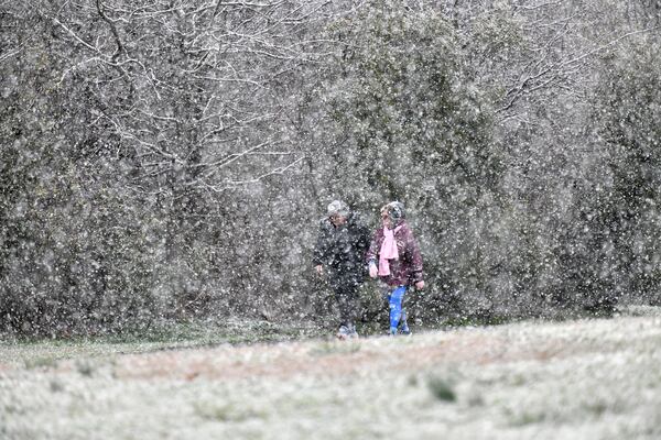 February 8, 2020 Lawrenceville - Leslie Spost (left) and Donna Glasser walk on a snow covered path at Alexander Park in Lawrenceville on Saturday, February 8, 2020. Some parts of North Georgia saw as much as 6 inches of snowfall Saturday morning, Channel 2 Action News reported. Northern Gwinnett County received more than 2 inches while some Atlanta residents saw an inch or more, Burns said. (Hyosub Shin / Hyosub.Shin@ajc.com)