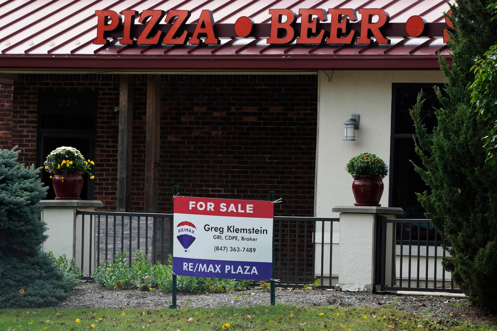 A "For Sale" sign is displayed outside of a restaurant in Waukegan, Ill., Saturday, Sept. 28, 2024. (AP Photo/Nam Y. Huh)