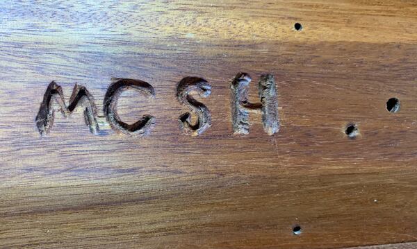 MCSH is carved into the bottom of the box Jim Galloway built from Max Cleland's old bed. It means Max Cleland slept here.