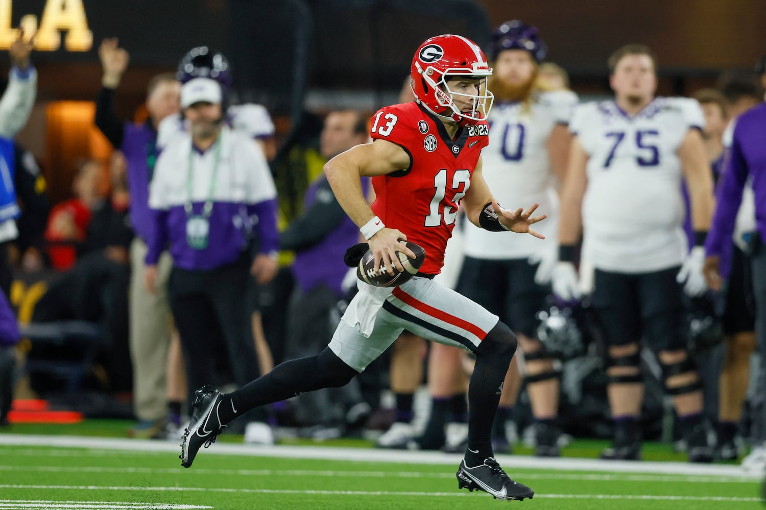 Georgia Bulldogs quarterback Stetson Bennett (13) runs against the TCU Horned Frogs during the first half of the College Football Playoff National Championship at SoFi Stadium in Los Angeles on Monday, January 9, 2023. (Jason Getz / Jason.Getz@ajc.com)