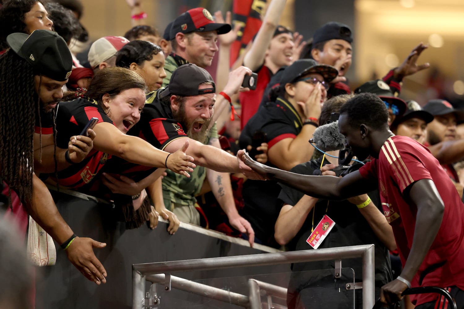 Atlanta United fans high five players after Atlanta United's 3-2 win against D.C. United at Mercedes-Benz Stadium Saturday, September 18, 2021 in Atlanta, Ga.. JASON GETZ FOR THE ATLANTA JOURNAL-CONSTITUTION