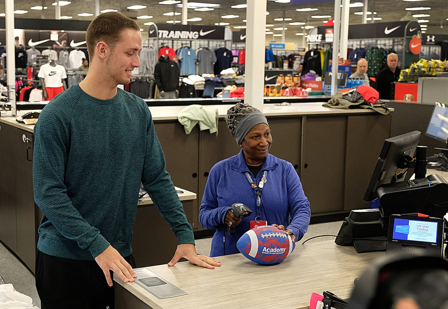 UGA quarterback Carson Beck and Academy employee Gwen Potts help families checkout after the Boys and Girls Club shopping spree at Academy. Carson Beck was on site at an Athens Academy store Sunday December 17, 2023, to give out gift cards to lucky members of area Boys and Girls Clubs. Academy contributed $200 for each child and he kicked in $135 more of his own money to help families out. 
Nell Carroll for the Journal-Constitution