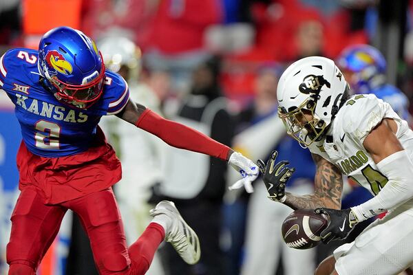 Colorado wide receiver Will Sheppard looses control the ball after a pass was broken up by Kansas cornerback Cobee Bryant (2) during the second half of an NCAA college football game, Saturday, Nov. 23, 2024, in Kansas City, Mo. (AP Photo/Charlie Riedel)