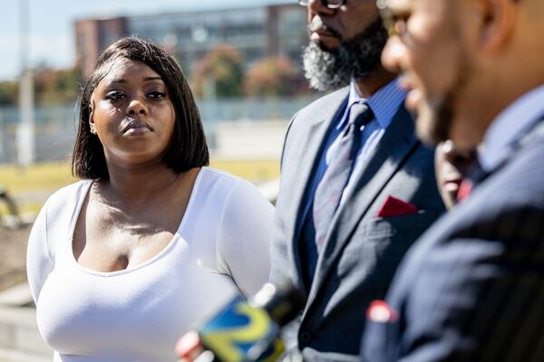 Plaintiff Martrice Herrington, an alumna of Fort Valley State University, listens to state lawmakers and lawyers speak on the steps of the Richard B. Russell Federal Building as they announce a federal lawsuit against the Georgia Board of Regents on Oct. 24, 2023.  (Steve Schaefer/AJC file photo)