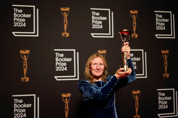 Samantha Harvey poses with the trophy after winning the Booker Prize award 2024, in London, Tuesday, Nov. 12, 2024. (AP Photo/Alberto Pezzali)