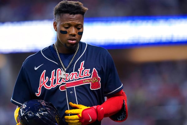 Atlanta Braves' Ronald Acuna Jr. walks off the field after grounding out and stranding two runners during the eighth inning of the team's baseball game against the Texas Rangers in Arlington, Texas, Saturday, April 30, 2022. The Rangers won 3-1. (AP Photo/LM Otero)