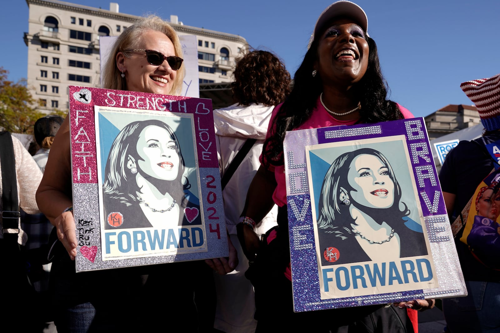 Demonstrator hold signs during the national Women's March at Freedom Plaza in Washington, Saturday, Nov. 2, 2024. (AP Photo/Jose Luis Magana)