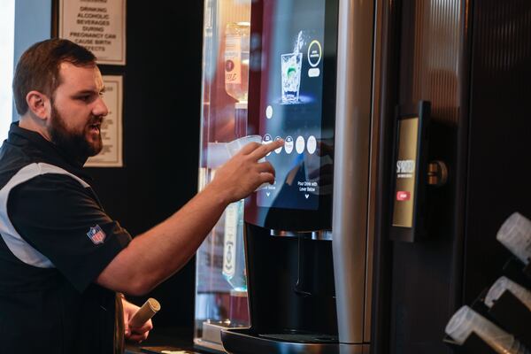 Ryan Trepte, senior director of strategy and innovation at Mercedes-Benz Stadium demonstrates how to use the Spirited Self-Service Cocktail station at Mercedes Benz Stadium on Wednesday, Sept. 4, 2024. (Natrice Miller/ AJC)