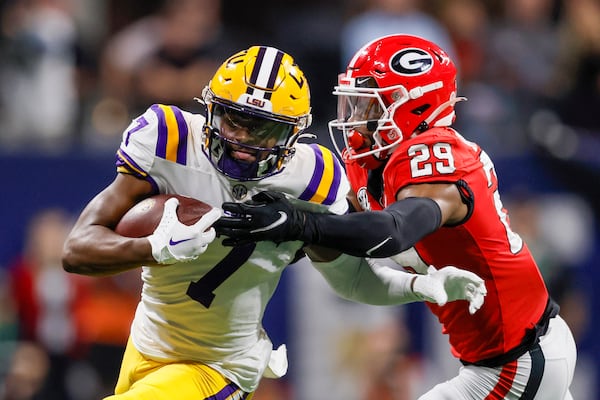 LSU Tigers wide receiver Kayshon Boutte (7) breaks away from Georgia Bulldogs defensive back Christopher Smith (29) for a touchdown during the first half of the SEC Championship Game at Mercedes-Benz Stadium in Atlanta on Saturday, Dec. 3, 2022. (Jason Getz / Jason.Getz@ajc.com)