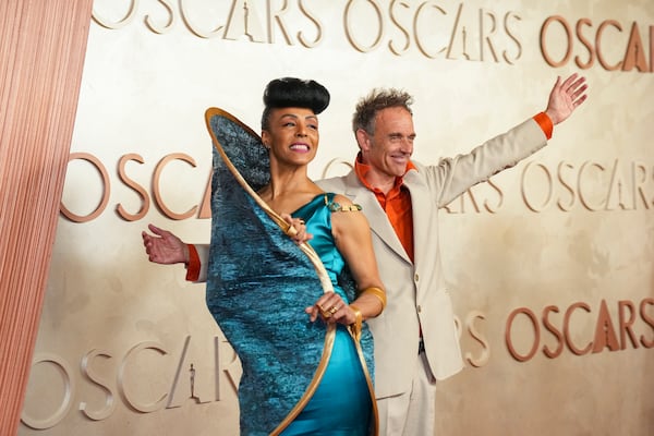 Kayo Shekoni, left, and Johan Grimonprez arrive at the Oscars on Sunday, March 2, 2025, at the Dolby Theatre in Los Angeles. (AP Photo/Jae C. Hong)