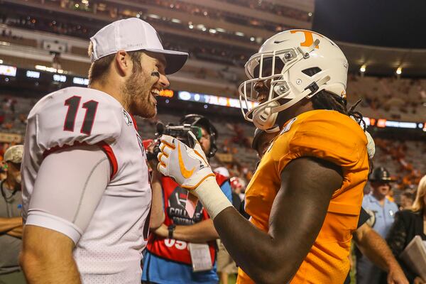 Georgia Bulldogs quarterback Jake Fromm (11) and Tennessee Volunteers wide receiver Marquez Callaway (1) speak following the game.  (Alyssa Pointer/Atlanta Journal Constitution)