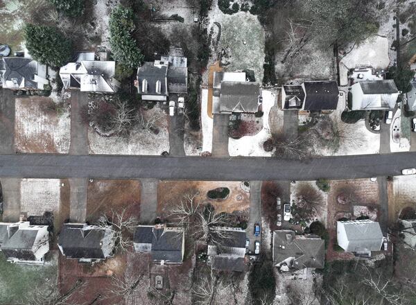 January 16, 2022 Snellville - Snow falls on houses in Snellville on Sunday, January 16, 2022. Snowfall continues to move south of I-285 and south Fulton and Coweta counties could see up to 2 inches of snow by Sunday evening. Major impacts near Lake Lanier and into the North Georgia mountains are being felt and certain spots could see up to 10 inches of snow. As of around noon, snow is moving through Troup and Coweta counties, as Fayette and Clayton counties still patiently wait for some flurries amidst the rain and some wintry mix. (Hyosub Shin / Hyosub.Shin@ajc.com)