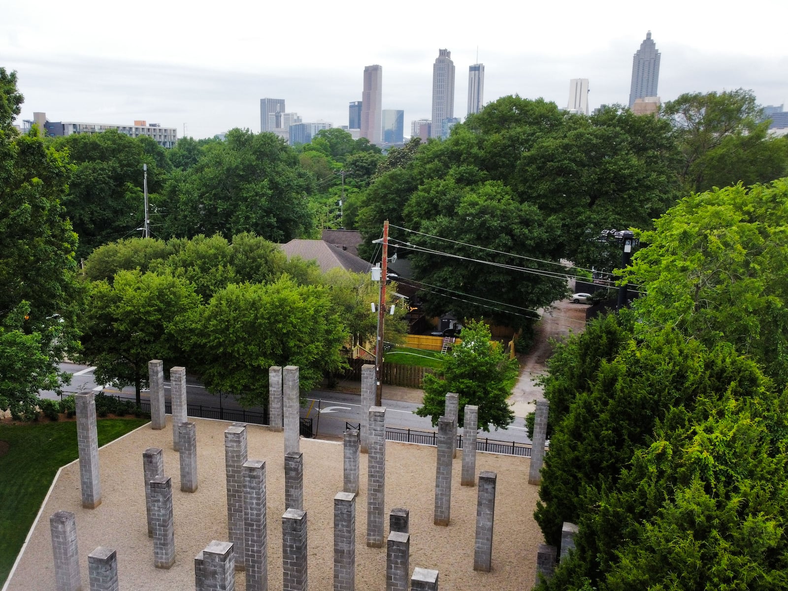 54 Columns Park, photographed by a drone, with the Atlanta skyline in the background. Artist Sol LeWitt intended the 54 pillars to evoke the Atlanta skyline, which was visible from the site before trees grew to obscure the view.