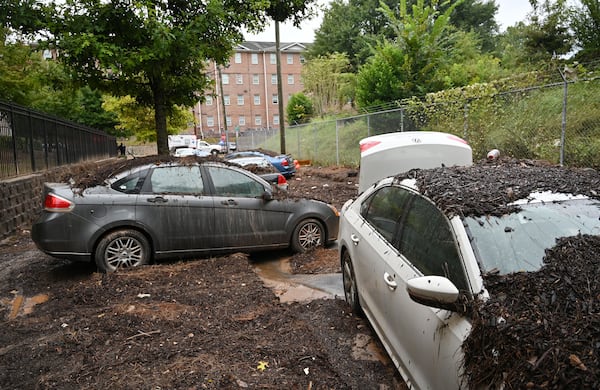 Damaged cars are stuck in the mud after storms dropped nearly four inches of rain near Clark Atlanta University campus, Friday, September 15, 2023, in Atlanta. Metro Atlanta is turning to cleanup efforts Friday after storms dropped nearly four inches of rain over downtown and caused major flash flooding that sent cars floating through streets the day before. (Hyosub Shin / Hyosub.Shin@ajc.com)