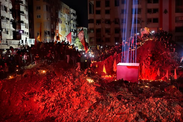 People gather at the site where former Hezbollah leader Sayyed Hassan Nasrallah was killed by Israeli airstrikes late September during a memorial ceremony in Dahiyeh, in the southern suburb of Beirut, Lebanon, Saturday, Nov. 30, 2024. (AP Photo/Hussein Malla)