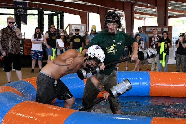 Jonathan Ramirez, left, of Orlando, Fla., and Liam Jones, of St. Augustine, Fla., compete in the Weaponized Pool Noodle Mud Wrestling event during the Florida Man Games, Saturday, March 1, 2025, in Elkton, Fla. (AP Photo/Phelan M. Ebenhack)