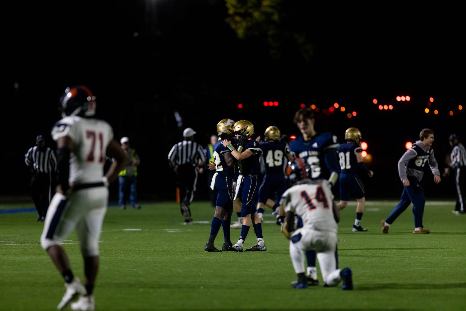 Mundy's Mill's Trashaun Burnett (14) is consoled by a St. Pius player as St. Pius celebrates a 27-21 win Friday night in Atlanta. (Photo/Jenn Finch)